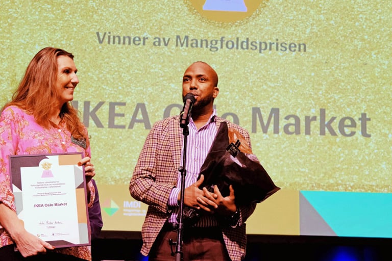 En mann som står ved siden av en kvinne på en scene.